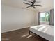 Bright bedroom with wood-look floors and ceiling fan at 7394 N 67Th Dr, Glendale, AZ 85303