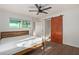 Bedroom with wood bed frame and barn door at 7394 N 67Th Dr, Glendale, AZ 85303