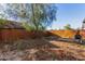 Backyard with wooden fence, mature tree, and grill at 7394 N 67Th Dr, Glendale, AZ 85303