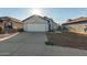 Single-story house with white garage door and landscaping at 7394 N 67Th Dr, Glendale, AZ 85303