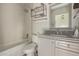 Clean bathroom with tub, gray vanity, and updated fixtures at 7394 N 67Th Dr, Glendale, AZ 85303