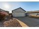 House exterior with white garage door and landscaping at 7394 N 67Th Dr, Glendale, AZ 85303