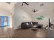 Open living area featuring a sectional sofa and blue accent doors at 7394 N 67Th Dr, Glendale, AZ 85303