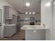 Modern kitchen with gray cabinets, quartz countertops, and geometric tile at 7394 N 67Th Dr, Glendale, AZ 85303