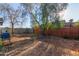 Large backyard with mature tree and wooden fence at 7394 N 67Th Dr, Glendale, AZ 85303