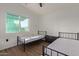 Bright bedroom with two beds, dresser, and large window at 7394 N 67Th Dr, Glendale, AZ 85303