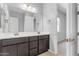 Modern bathroom with double vanity, gold fixtures, and dark brown cabinets at 22788 E Orion Way, Queen Creek, AZ 85142
