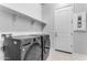 Laundry room with washer, dryer, and overhead shelving at 22788 E Orion Way, Queen Creek, AZ 85142