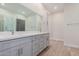 Modern bathroom with double vanity, quartz countertop and gray cabinets at 16970 W Baker St, Surprise, AZ 85387