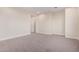 Simple bedroom with neutral carpeting and an ensuite bathroom at 16970 W Baker St, Surprise, AZ 85387