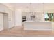 Modern kitchen features white cabinets, quartz countertops, and a patterned backsplash at 16970 W Baker St, Surprise, AZ 85387