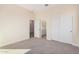 Spacious bedroom with carpet flooring and access to a bathroom at 16970 W Baker St, Surprise, AZ 85387