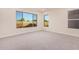 Bright bedroom with neutral carpeting and large windows at 16970 W Baker St, Surprise, AZ 85387