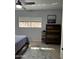 Bright bedroom featuring a large window, dresser, and ceiling fan at 6415 S Newberry Rd # C, Tempe, AZ 85283