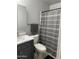 Clean bathroom with marble vanity, shower, and gray shower curtain at 6415 S Newberry Rd # C, Tempe, AZ 85283