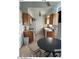 Bright kitchen with wood cabinets, black countertops, and breakfast nook at 6415 S Newberry Rd # C, Tempe, AZ 85283