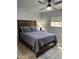 Bedroom with wooden bed frame, gray bedding, and tiled floors at 6415 S Newberry Rd # C, Tempe, AZ 85283