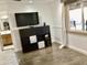 Bedroom with a TV, built in shelving and hardwood floors at 11602 W Carol Ave, Youngtown, AZ 85363