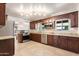 Well-equipped kitchen with granite countertops and dark wood cabinets at 127 E Garfield St, Tempe, AZ 85288