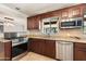 Kitchen with stainless steel appliances and granite countertops at 127 E Garfield St, Tempe, AZ 85288