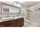 Double vanity bathroom with granite countertops and stone tile at 127 E Garfield St, Tempe, AZ 85288