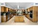 Spacious kitchen with island, stainless steel appliances, and wood cabinets at 6644 E Exeter Blvd, Scottsdale, AZ 85251
