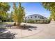 Circular driveway leading to a contemporary home with mature trees at 6644 E Exeter Blvd, Scottsdale, AZ 85251