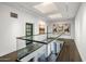 Modern glass-railed hallway with natural light and artwork at 6644 E Exeter Blvd, Scottsdale, AZ 85251