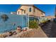 Landscaped backyard with a blue block wall, plants and decorative items at 19104 N Smith Dr, Maricopa, AZ 85139