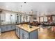 Open kitchen features granite island, stainless steel appliances, and flows into Gathering room at 19104 N Smith Dr, Maricopa, AZ 85139