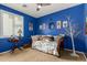 Charming bedroom with daybed, blue walls, and decorative accents at 19104 N Smith Dr, Maricopa, AZ 85139