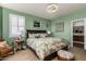 Main bedroom with plush carpet, large bed, and plenty of natural light at 19104 N Smith Dr, Maricopa, AZ 85139