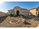 Tan house with arched entryway and two-car garage at 19104 N Smith Dr, Maricopa, AZ 85139