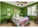 Guest bedroom with full-size bed, green walls, and plenty of light at 19104 N Smith Dr, Maricopa, AZ 85139