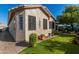 Tan stucco house with a partial view of the backyard and landscaping at 19104 N Smith Dr, Maricopa, AZ 85139