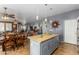 Open concept kitchen with island and view into living room at 19104 N Smith Dr, Maricopa, AZ 85139