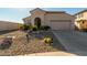 Tan house with arched entryway and two-car garage at 19104 N Smith Dr, Maricopa, AZ 85139