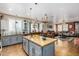 Open kitchen features granite island, stainless steel appliances, and flows into Gathering room at 19104 N Smith Dr, Maricopa, AZ 85139