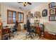 Home office with two desks, seating, and ample natural light at 19104 N Smith Dr, Maricopa, AZ 85139