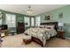 Main bedroom with plush carpet, large bed, and plenty of natural light at 19104 N Smith Dr, Maricopa, AZ 85139