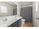 Modern bathroom with a double vanity and patterned shower curtain at 6439 W Fawn Dr, Laveen, AZ 85339