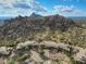 Aerial view showcasing community setting with rugged mountain backdrop at 27440 N Alma School Pkwy # 33-2, Scottsdale, AZ 85262