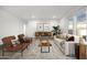 Bright living room featuring a comfy sofa, armchairs, and a wooden coffee table at 8009 W Jadan St, Coolidge, AZ 85128