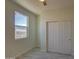 Bright bedroom with ceiling fan, closet, and tile flooring at 527 W Mobile Ln, Phoenix, AZ 85041