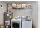 Bright laundry room with washer, dryer, and shelving at 7830 N 17Th Ave, Phoenix, AZ 85021