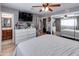Bedroom with large dresser, TV, and en-suite bathroom access at 7830 N 17Th Ave, Phoenix, AZ 85021