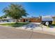 Brick ranch house with a landscaped yard, driveway, and solar panels at 7830 N 17Th Ave, Phoenix, AZ 85021