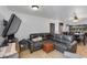 Comfortable living area with a gray sectional sofa and a large TV at 7830 N 17Th Ave, Phoenix, AZ 85021