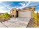 Single story home with two car garage and desert landscaping at 13618 W Shifting Sands Dr, Peoria, AZ 85383