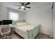 Bright bedroom with a queen-size bed and ceiling fan at 14231 W Bronco Trl, Surprise, AZ 85387